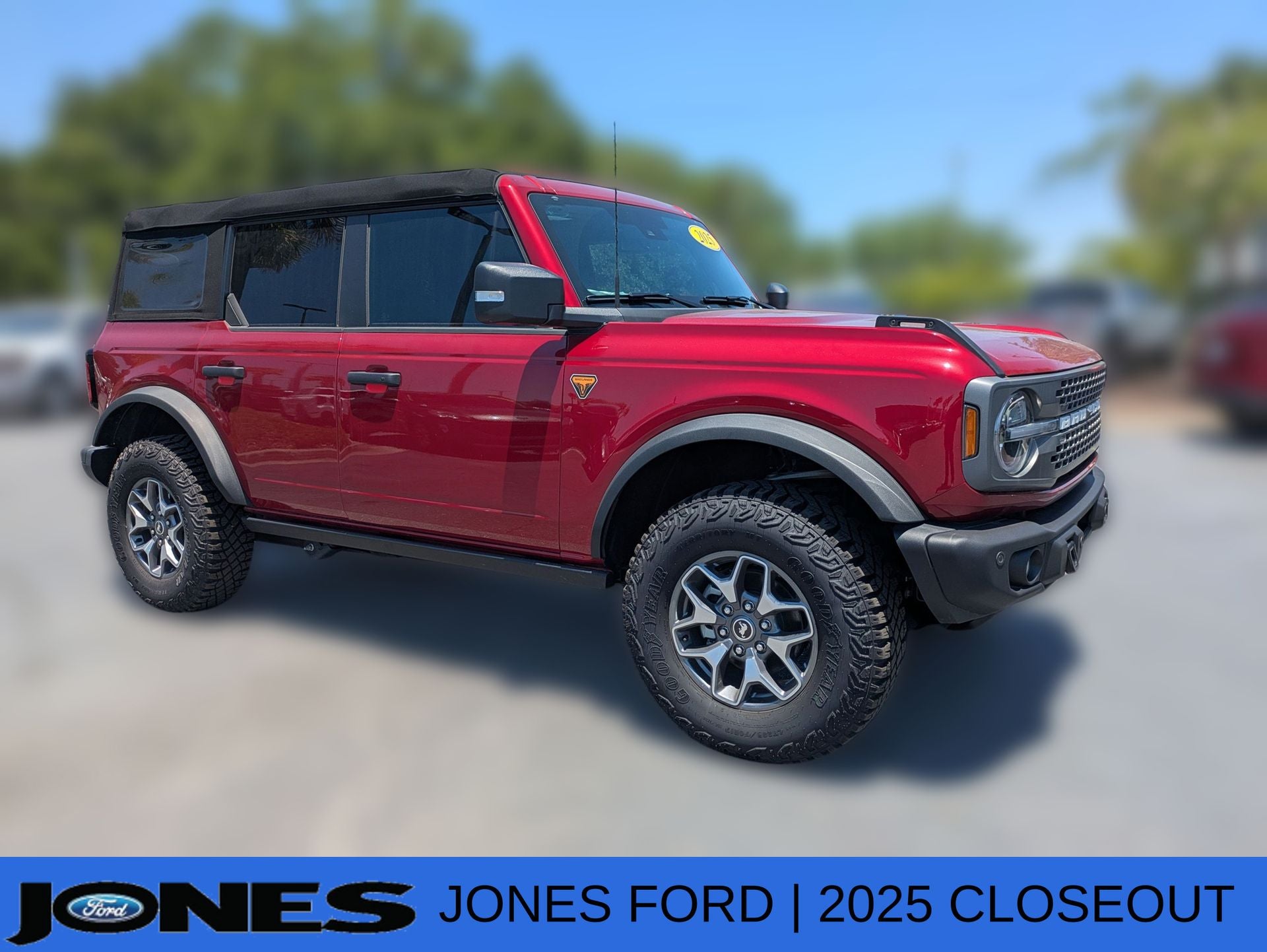 2025 Ford Bronco Badlands in Ruby Red Metallic Tinted Clearcoat — front three-quarter view